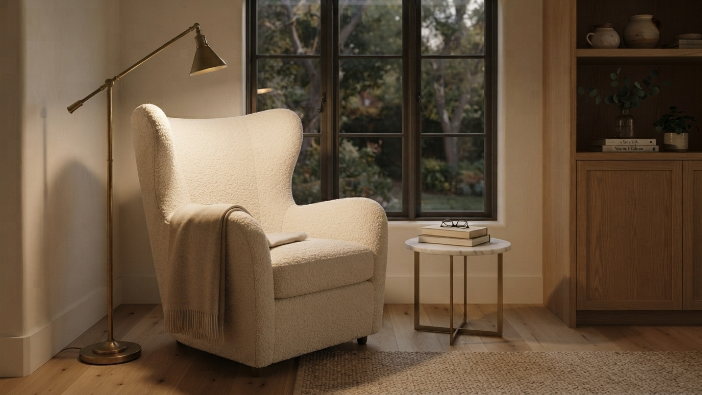 Luxury cozy reading nook idea with a bouclé wingback chair and brass floor lamp